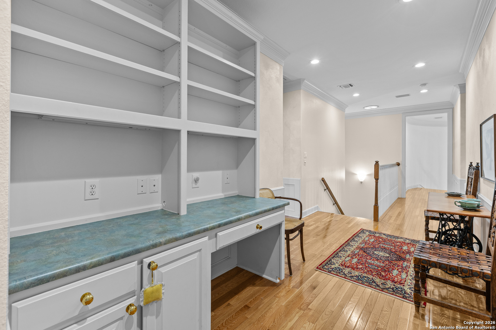 10924 Reyes Canyons Helotes, TX 78023 - Photo 48 of 61 a view of a kitchen with kitchen island a sink wooden floor and a counter top space