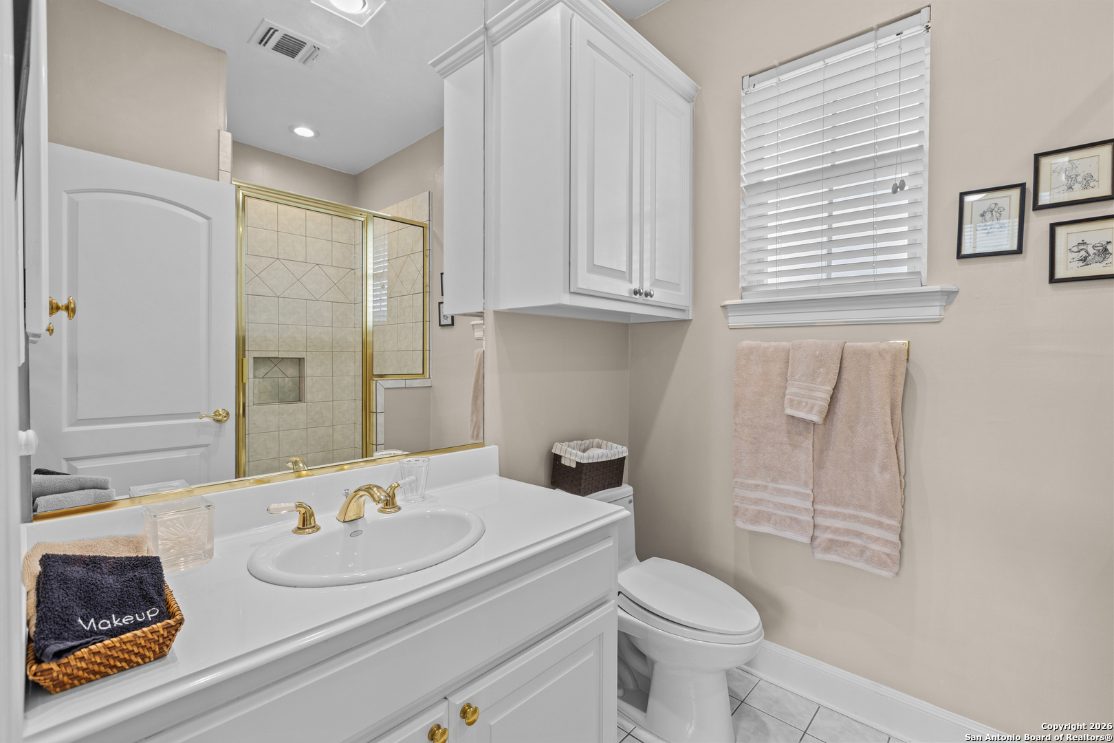 10924 Reyes Canyons Helotes, TX 78023 - Photo 54 of 61 a bathroom with a granite countertop sink mirror vanity and toilet