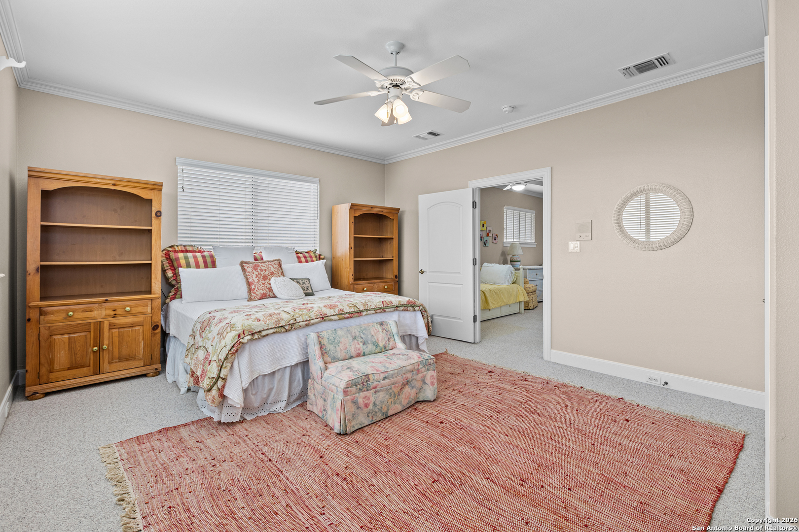 10924 Reyes Canyons Helotes, TX 78023 - Photo 56 of 61 a bedroom with a large bed and a chandelier