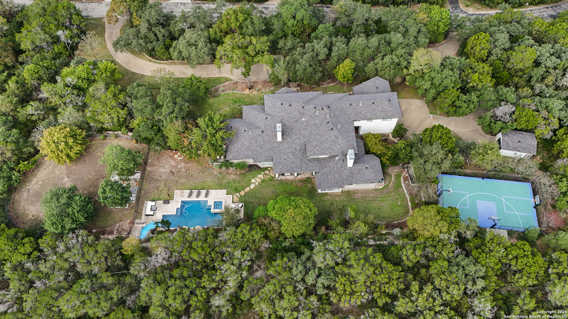 10924 Reyes Canyons Helotes, TX 78023 - Photo 60 of 61 an aerial view of a house with a yard and trees all around