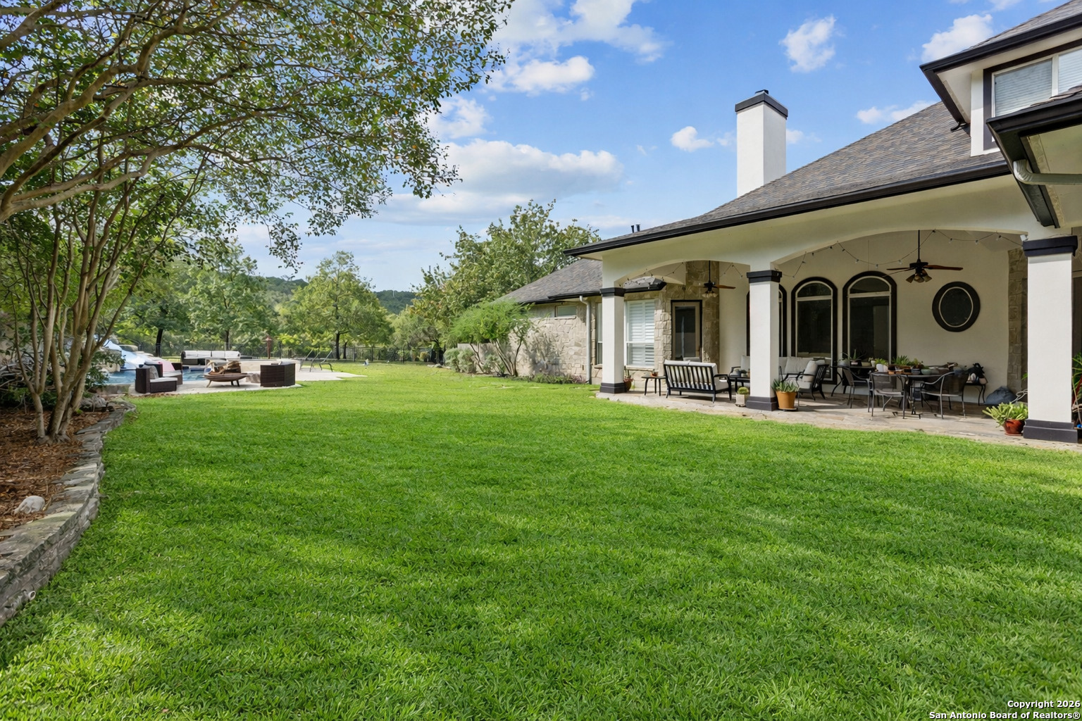 10924 Reyes Canyons Helotes, TX 78023 - Photo 10 of 61 a front view of house with a garden and trees