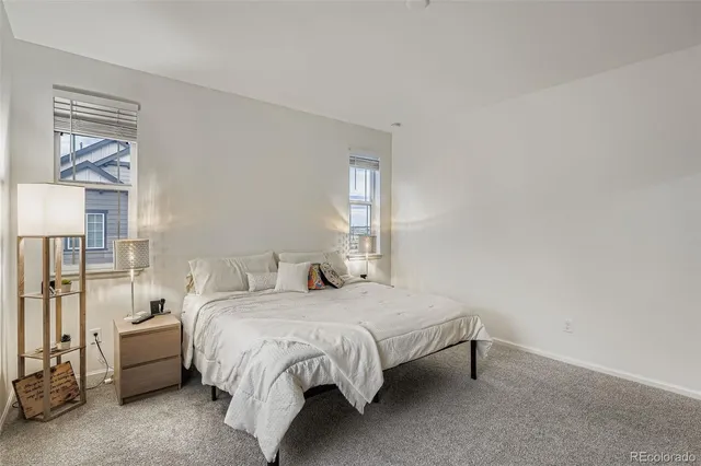 a bedroom with a bed and large window