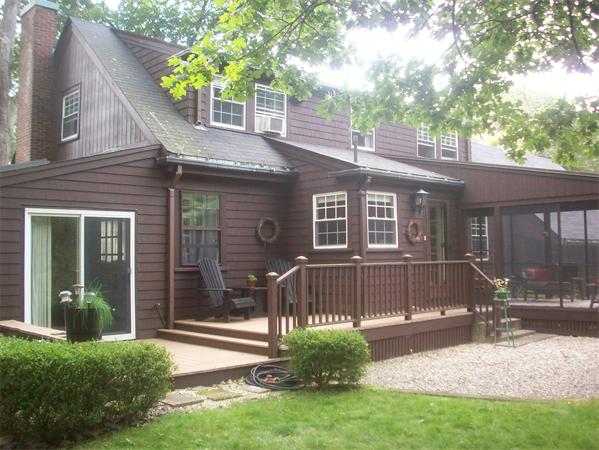 62 Oak Ridge Road Reading, MA 01867 - Photo 7 of 28 a front view of a house with a yard