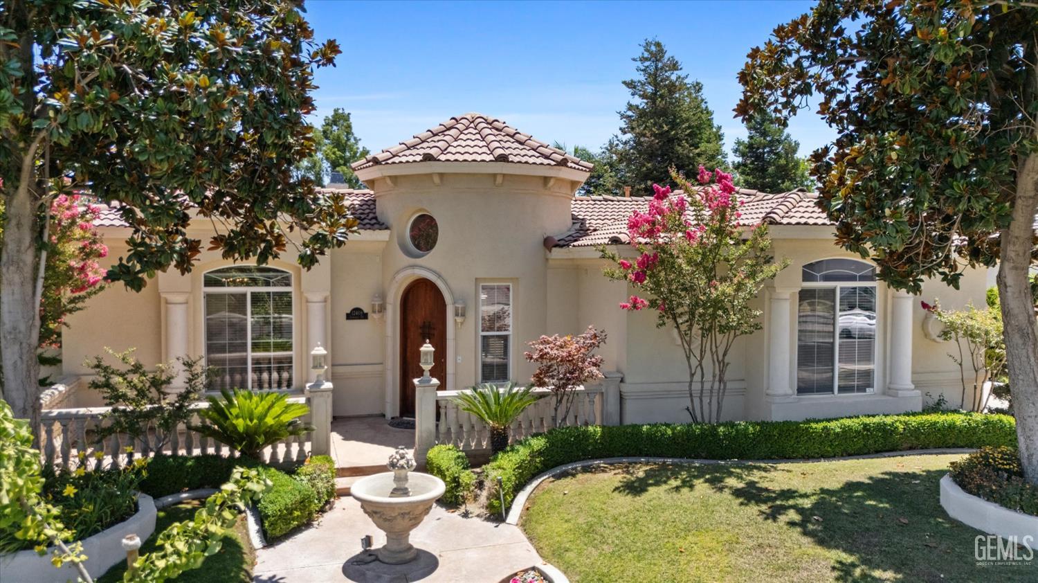 a front view of a house with a garden