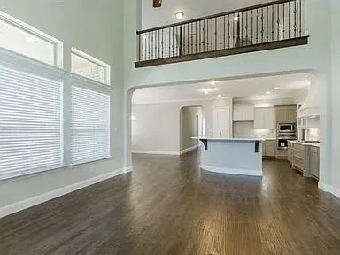 a view of a living room and kitchen with furniture wooden floor and a kitchen
