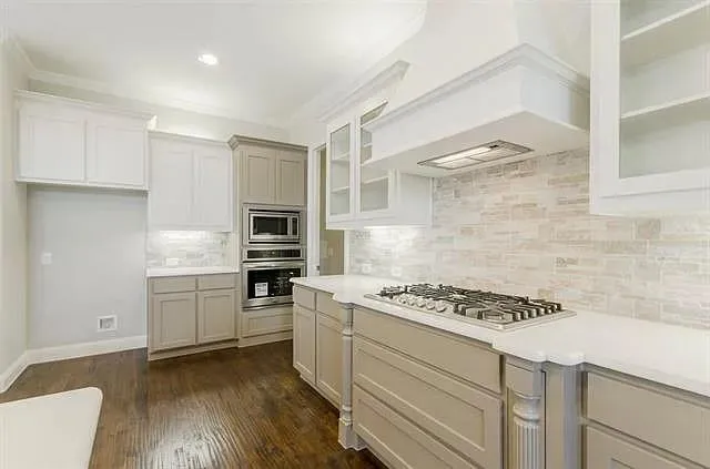 a kitchen with granite countertop cabinets and steel stainless steel appliances