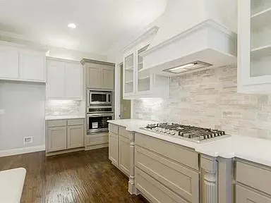 a kitchen with granite countertop a stove and a refrigerator