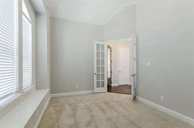 a view of an empty room with a window