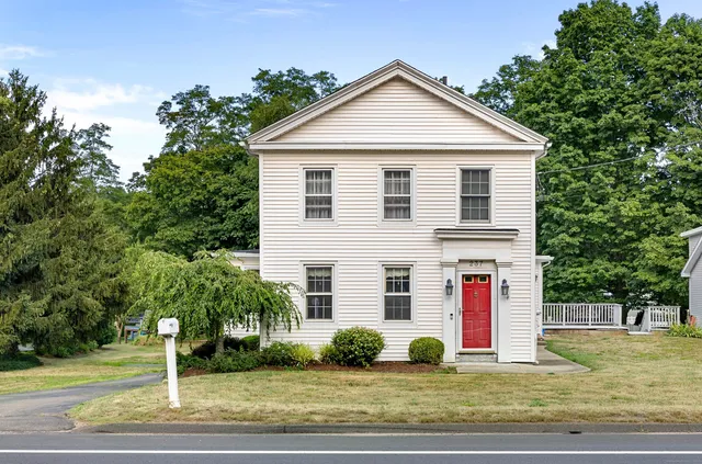 a front view of building with yard and parking