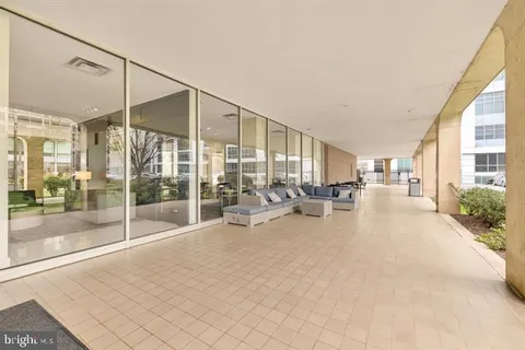 a view of a livingroom with furniture and floor to ceiling window