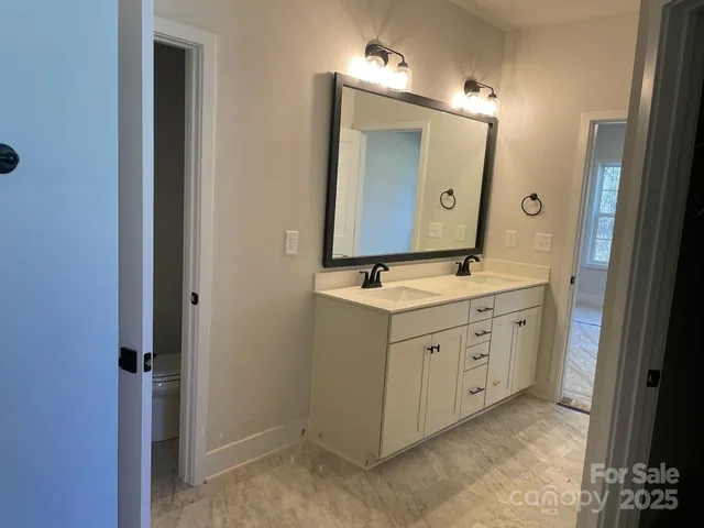 a view of a chandelier in a room and a bathroom
