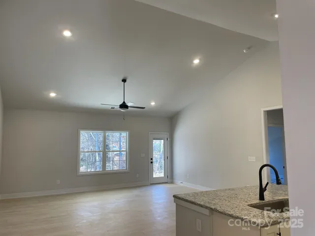a kitchen with stainless steel appliances a sink and a hard wood floor