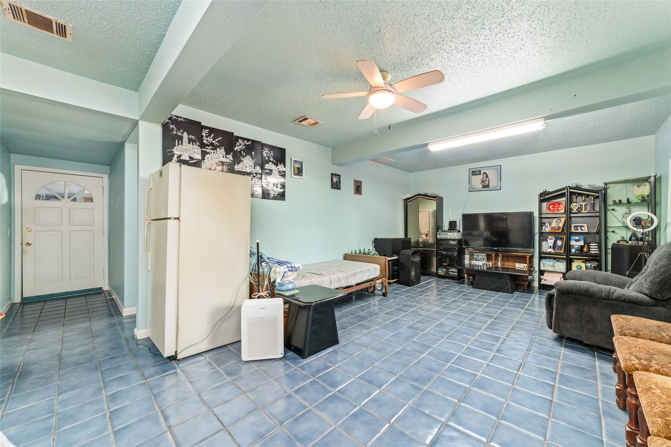8023 Findlay Street Houston, TX 77017 - Photo 12 of 24 a living room with furniture and a refrigerator