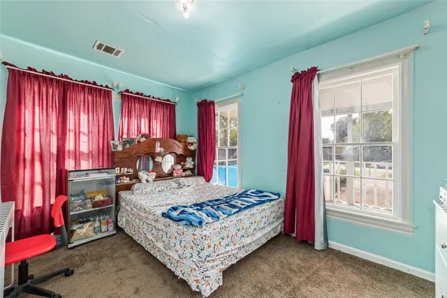 a bed room with a bed and a window