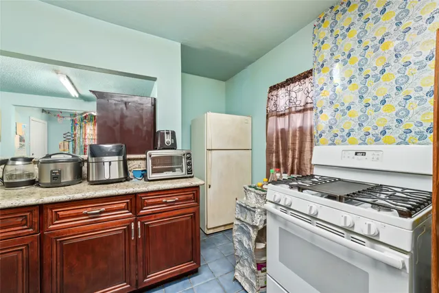 a kitchen with stainless steel appliances granite countertop a stove and a refrigerator