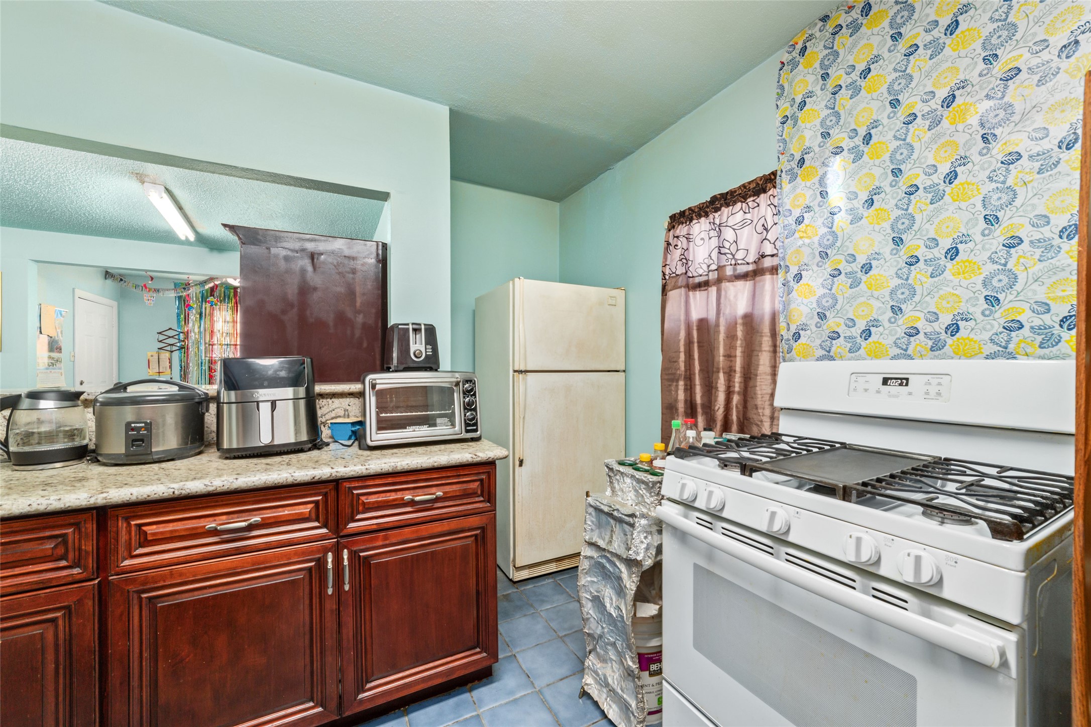 8023 Findlay Street Houston, TX 77017 - Photo 7 of 24 a kitchen with stainless steel appliances granite countertop a stove and a refrigerator