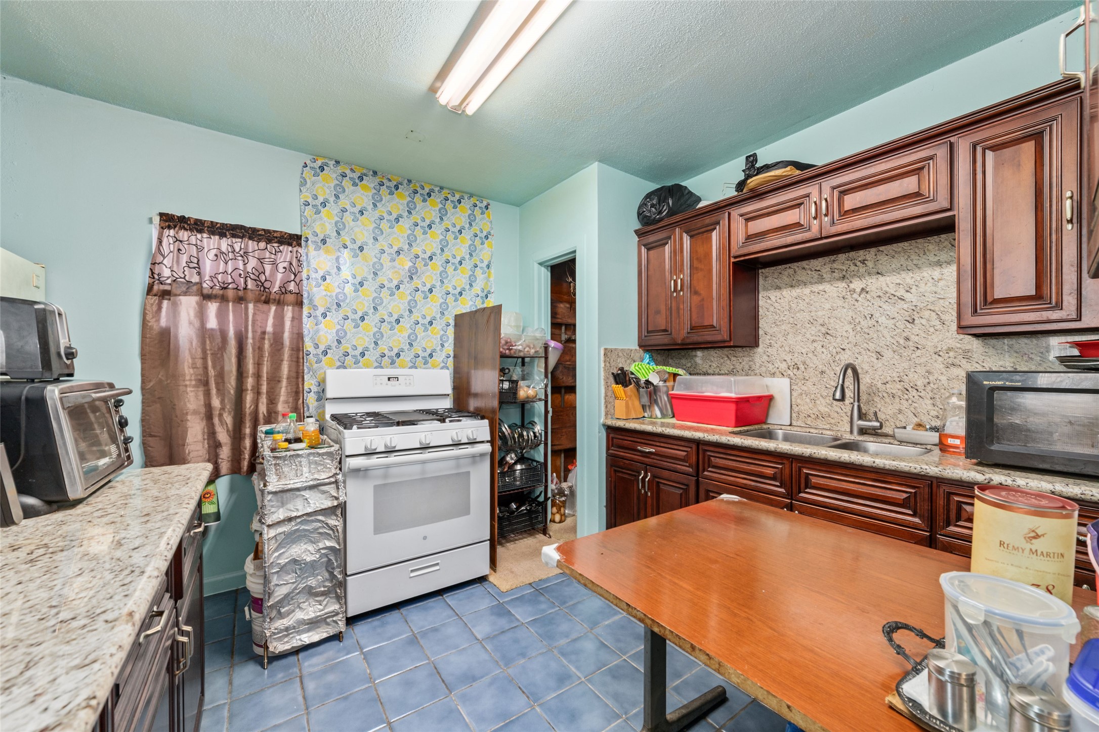 8023 Findlay Street Houston, TX 77017 - Photo 9 of 24 a kitchen with stainless steel appliances granite countertop a stove refrigerator sink and cabinets