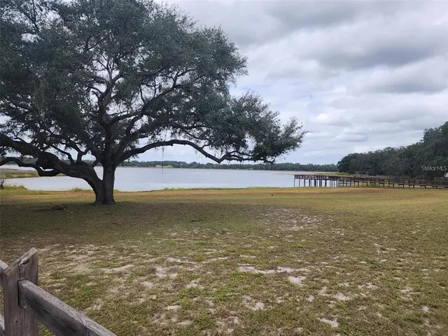 a view of a lake with houses in the back