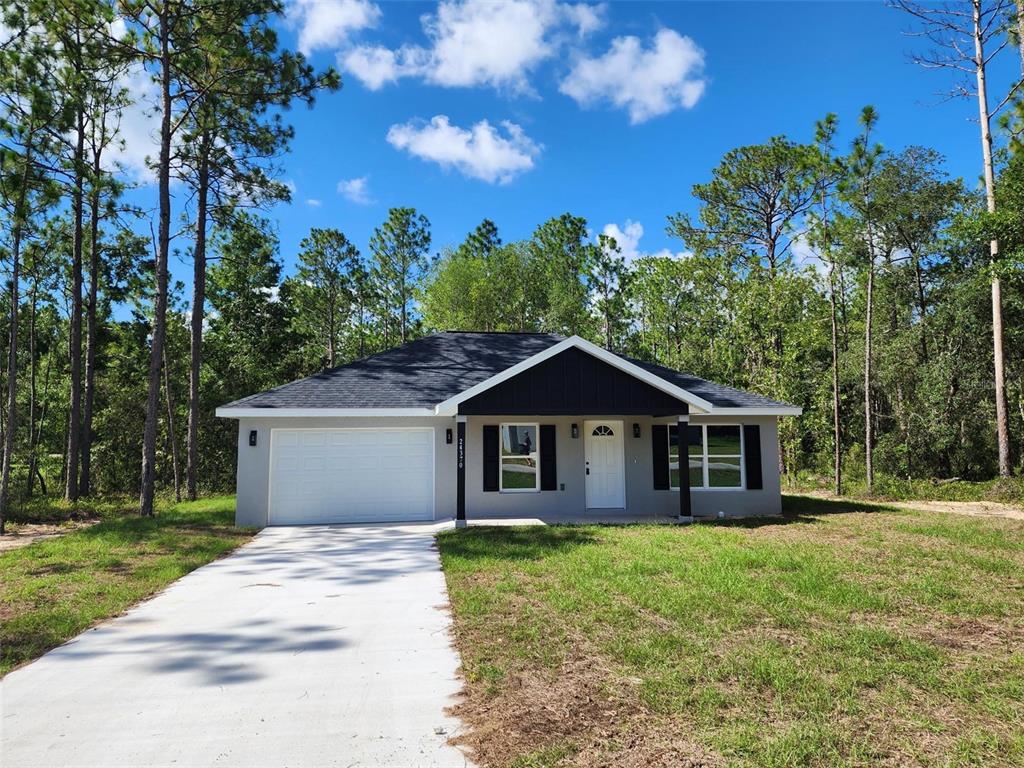 24370 Falcon Avenue Dunnellon, FL 34431 - Photo 2 of 24 a front view of a house with a garden