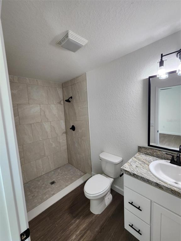 24370 Falcon Avenue Dunnellon, FL 34431 - Photo 7 of 24 a bathroom with a granite countertop shower a toilet and a sink