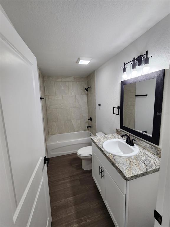 24370 Falcon Avenue Dunnellon, FL 34431 - Photo 8 of 24 a bathroom with a granite countertop sink and mirror with bathtub