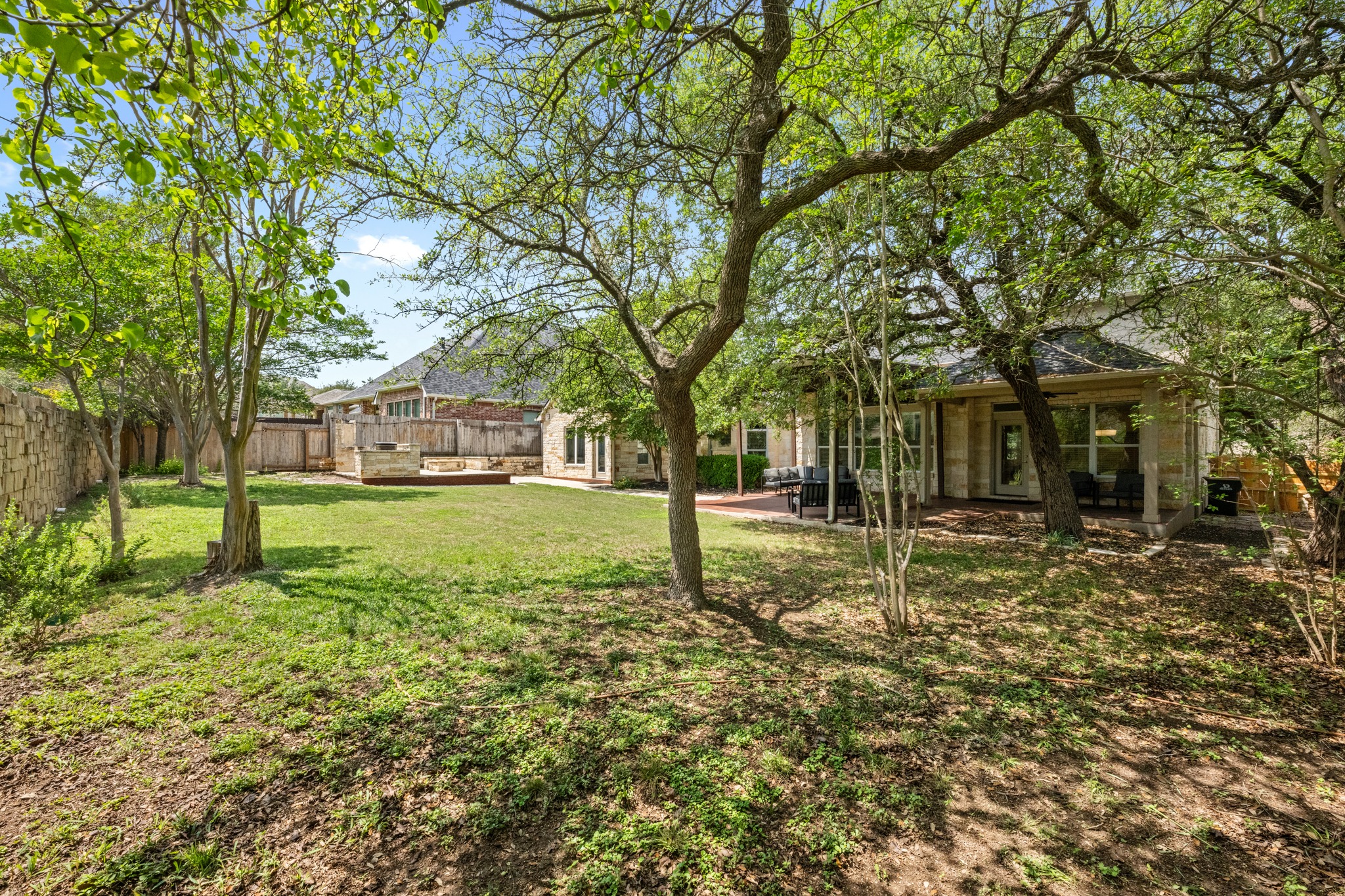 1023 Grassy Field Road Austin, TX 78737 - Photo 36 of 40 Expansive backyard featuring mature trees with lots of shade.