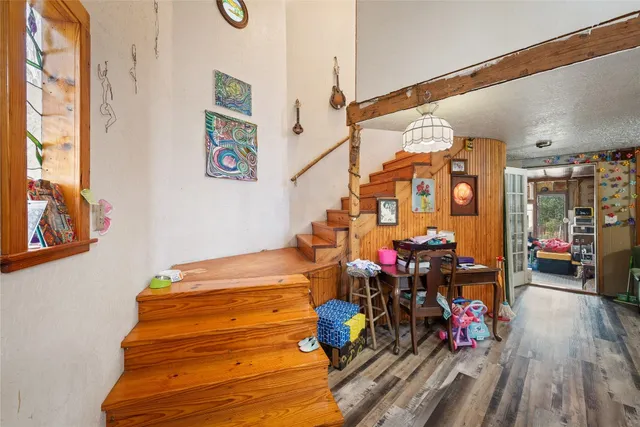 a bedroom with a bed wooden floor and a window