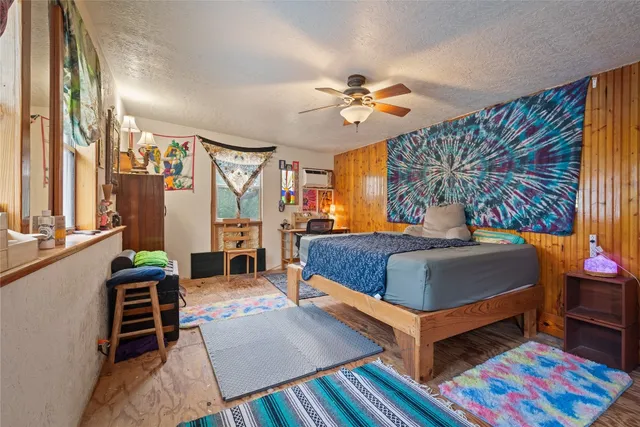 a bedroom with a bed and a painting on the wall