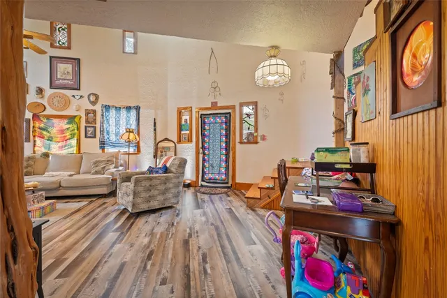 a living room with furniture a rug and a chandelier