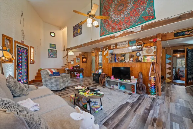 a living room with furniture a rug and a large window