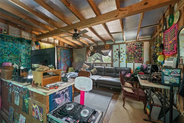 a view of a hallway with a dining table and chandelier