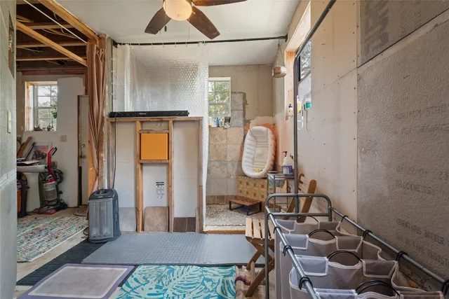 a view of a house with a lush green forest