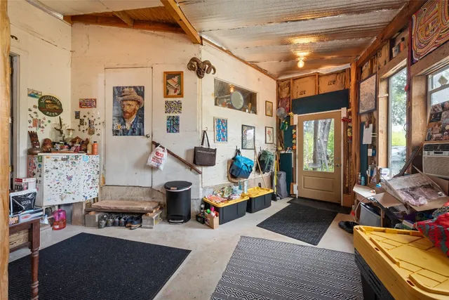 a view of a hallway with wooden floor and windows