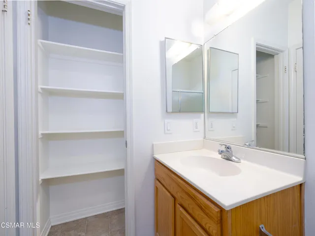 a bathroom with a sink vanity and a mirror