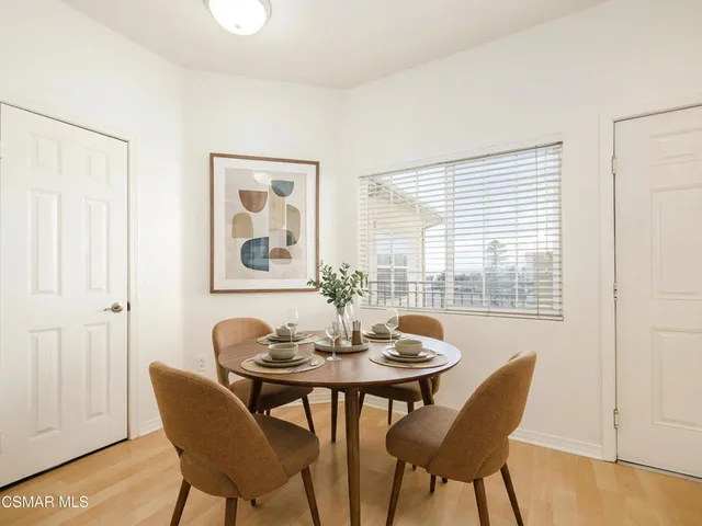 a dining room with furniture and window