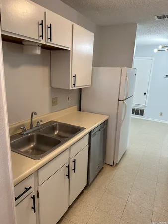 a utility room with cabinets and a sink