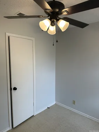 a view of a chandelier fan and closet