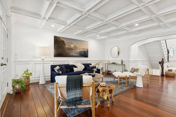 a living room with lots of furniture and wooden floor