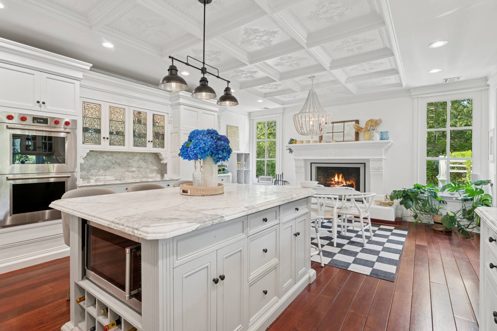 Undisclosed Address Remsenburg, NY 11960 - Photo 13 of 35 a kitchen with kitchen island a wooden floor and a fireplace