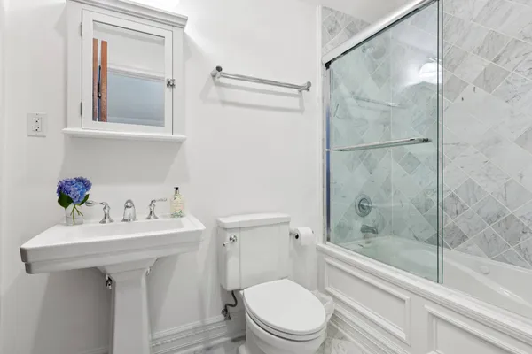 a bathroom with a sink toilet and shower