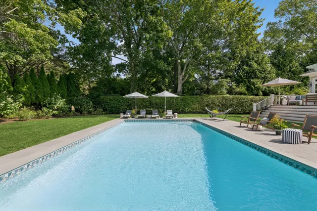 a view of swimming pool with outdoor seating and garden