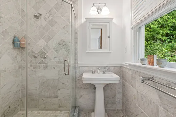 a bathroom with a sink mirror and window