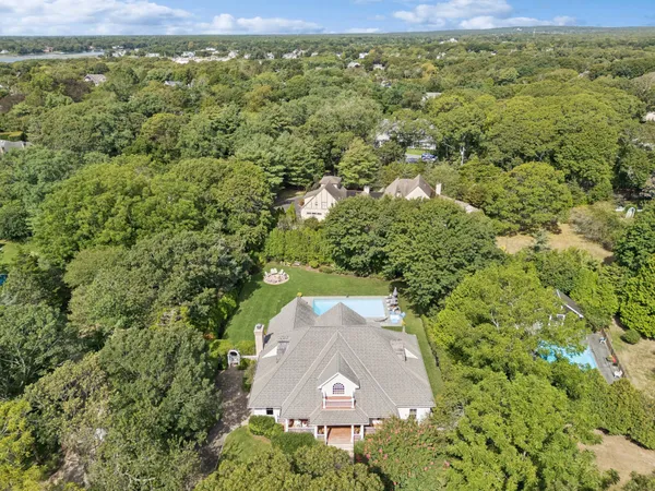a aerial view of a house with a yard and large tree