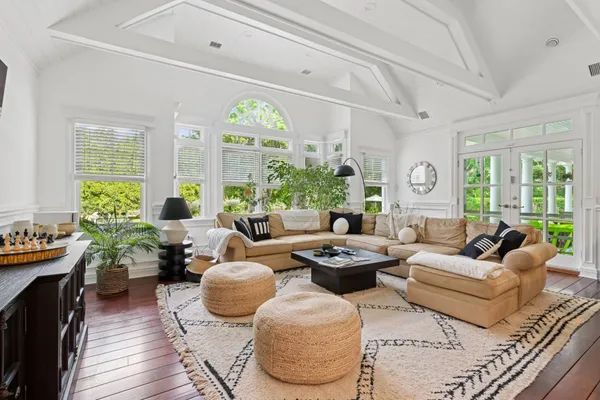 a living room with furniture potted plant and a large window