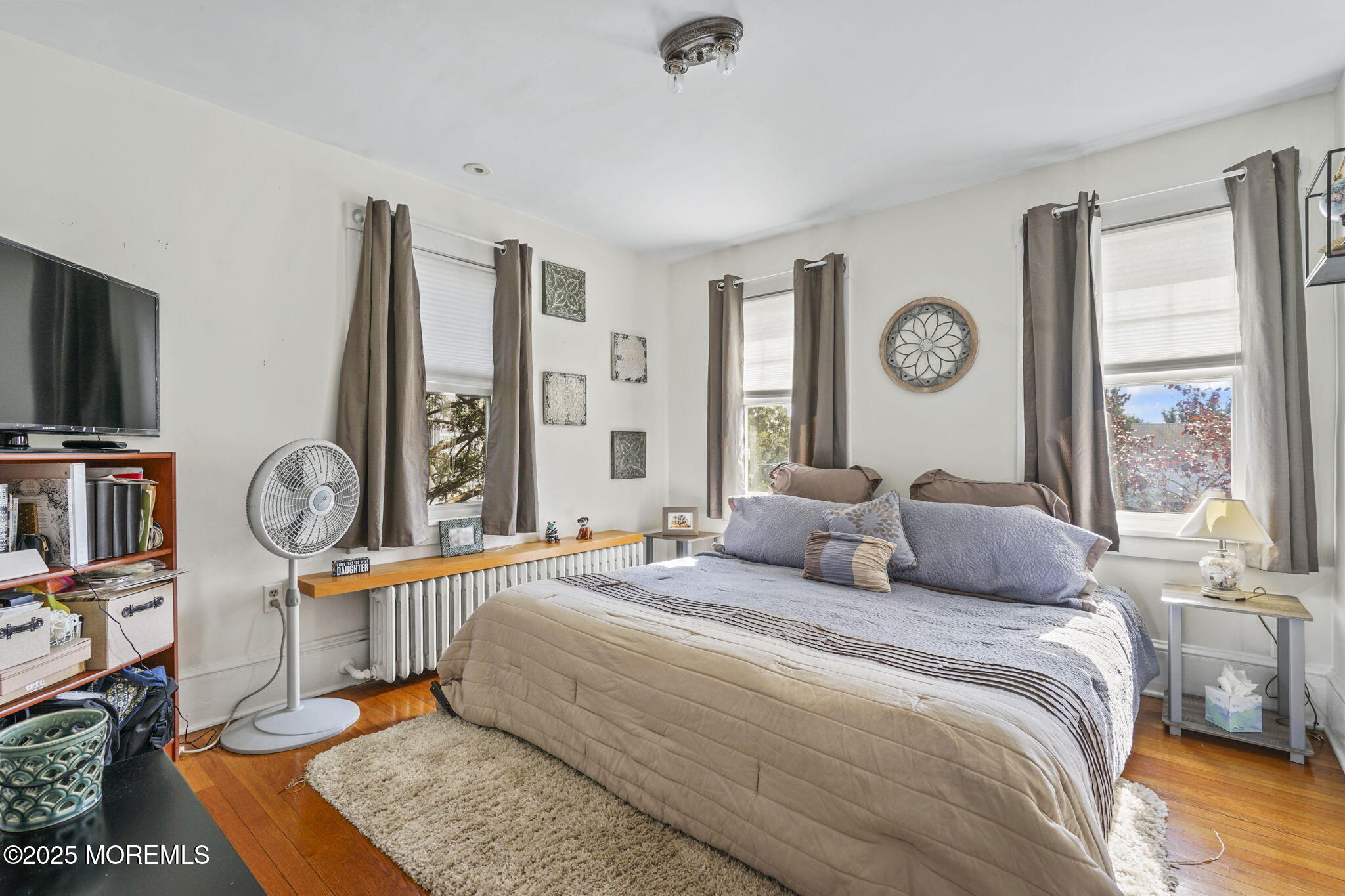 22 Albany Road Neptune Township, NJ 07753 - Photo 16 of 40 a bedroom with a bed a flat screen tv and a large window
