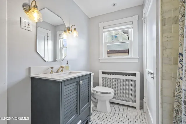 a bathroom with a sink a toilet and a mirror