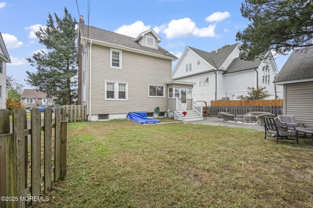 a backyard of a house with table and chairs