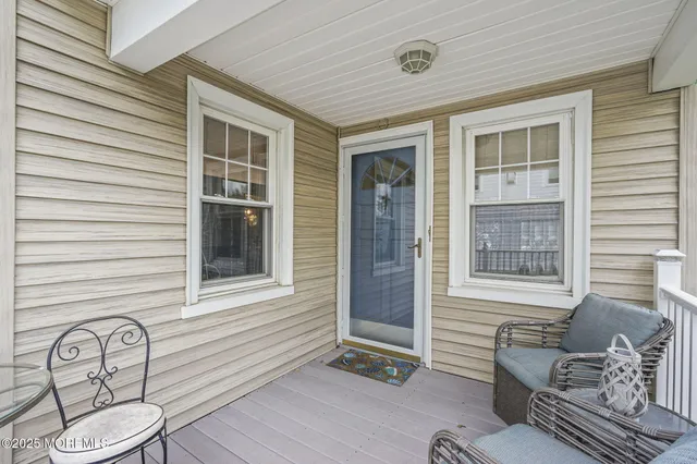 a front view of a house with outdoor seating