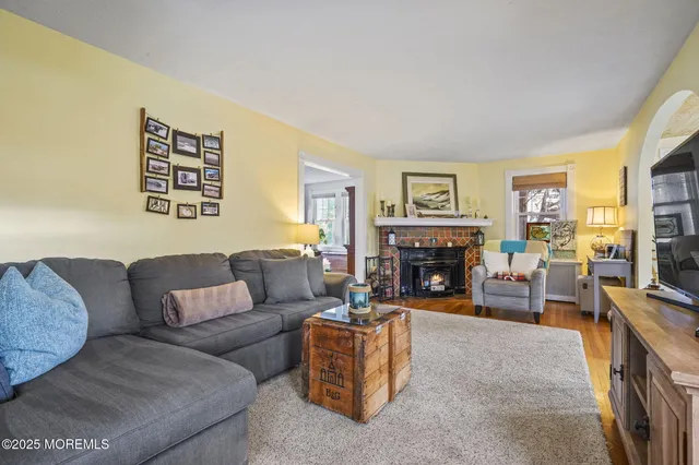 a living room with furniture large window and a fireplace