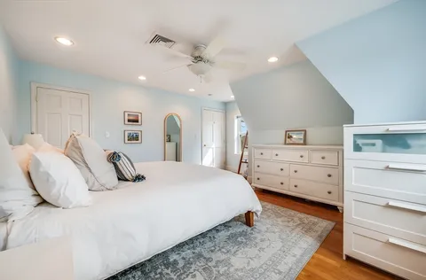 a bedroom with a bed and a dresser